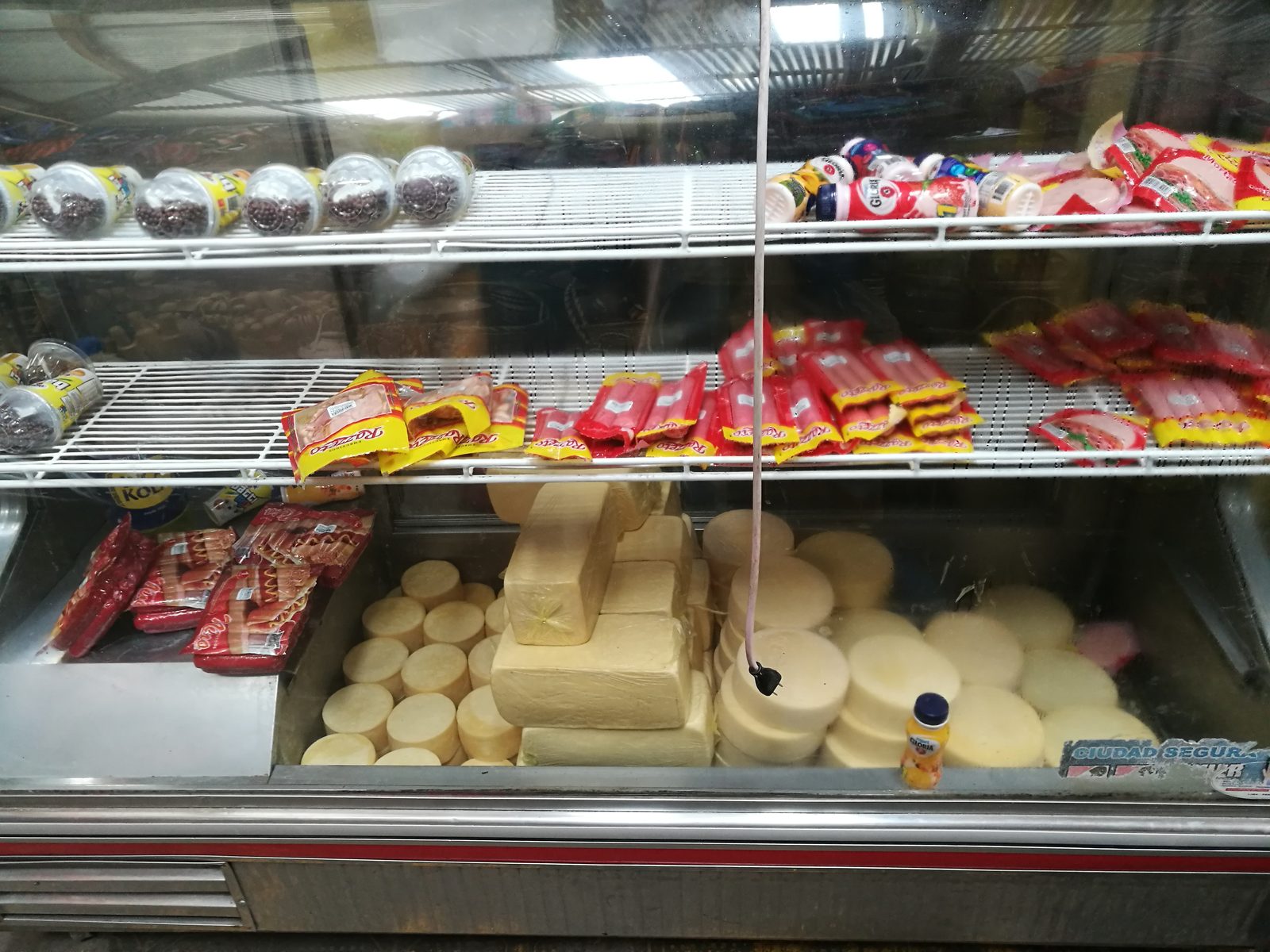A cheese counter stacked with wheels in the Mercado Central